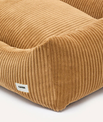 Close-up of mustard corduroy fabric and CAFIDE label