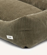 Close-up of green corduroy fabric and CAFIDE label