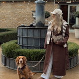 Woman walking a brown spaniel outdoors with the Cotswolds Check lead