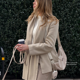 Woman outdoors holding the coiled London Linen Stripes lead with a matching shoulder bag, by Cocopup London