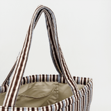 Open top view of the striped tote bag showing the light interior and internal pocket
