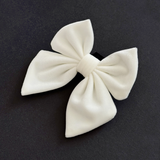 Cocopup London White Luxe Velvet Sailor Bow Tie angled on a dark background