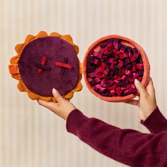 Hands opening the Berry Pie snuffle dog toy to reveal its treat-searching base