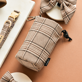 Close angled view of Pup Plaid treat pouch showing tartan fabric and black drawstring