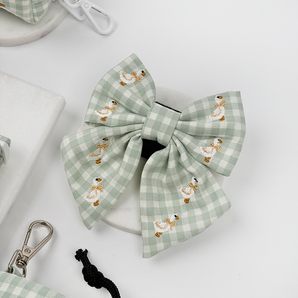 Silly Goose Sailor Bow Tie by Cocopup London angled in a pale product flat lay