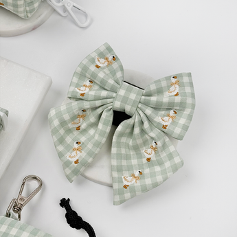 Silly Goose Sailor Bow Tie by Cocopup London angled in a pale product flat lay