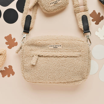 Teddy Rupert dog walking bag front view showing cream teddy texture, zip and strap clips