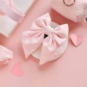 Cocopup London Baby Pink Heart Luxe Sailor Bow Tie in a pink accessories flat lay