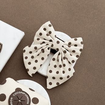 Tiramisu Polka Dot Sailor Bow Tie by Cocopup London in a neutral flat lay