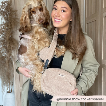 Woman holding a spaniel while wearing Teddy Rupert walking bag crossbody