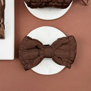 Front view of the Cocopup London Espresso Quilted Bow Tie on a white dish