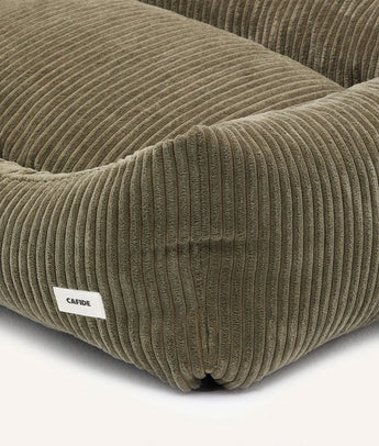 Close-up of green corduroy fabric and CAFIDE label