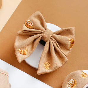 Pawtisserie Sailor Bow Tie by Cocopup London angled on a white plate with pastry embroidery visible