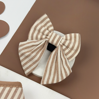 London Linen Stripes Sailor Bow Tie angled in a neutral brown flat lay, by Cocopup London