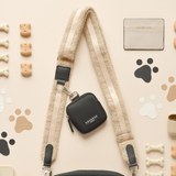 Teddy Rupert bag strap attached to a small black Cocopup London bag in a flat lay