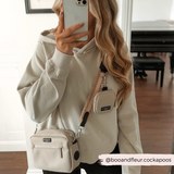 Woman wearing the Teddy Rupert strap with a cream Cocopup London crossbody bag indoors