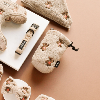 Theo Embroidered Teddy treat pouch angled among matching cream teddy accessories