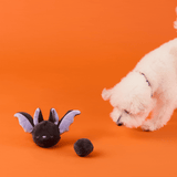 Animated demonstration of a dog playing with the Bat toy and removable ball