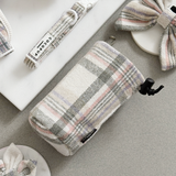 Oxford Plaid drawstring treat pouch angled in a flat lay with matching pastel accessories