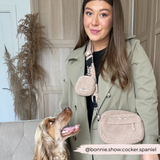 Woman wearing Teddy Rupert walking bag and matching pouch while a spaniel looks up