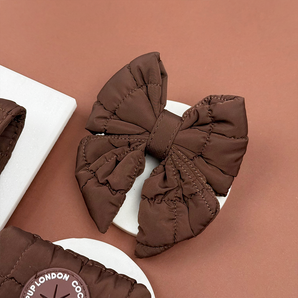 Cocopup London Espresso Quilted Sailor Bow Tie angled in a brown flat lay