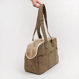 Cotswold Check dog carrier held by its handles, showing cream-lined side opening