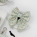 Silly Goose Sailor Bow Tie by Cocopup London angled in a pale product flat lay