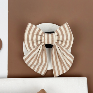 Front view of the London Linen Stripes Sailor Bow Tie on a white dish, by Cocopup London