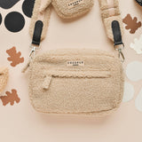 Teddy Rupert dog walking bag front view showing cream teddy texture, zip and strap clips