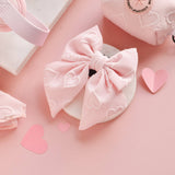 Cocopup London Baby Pink Heart Luxe Sailor Bow Tie in a pink accessories flat lay