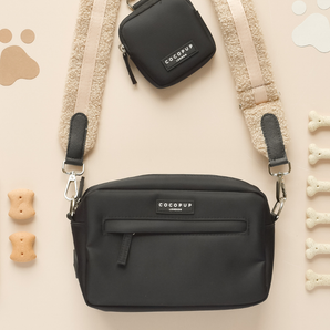 Teddy Rupert bag strap attached to a black Cocopup London dog walking bag