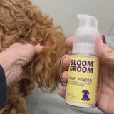 Bloom Groom Poof Powder demonstrated on a curly dog coat
